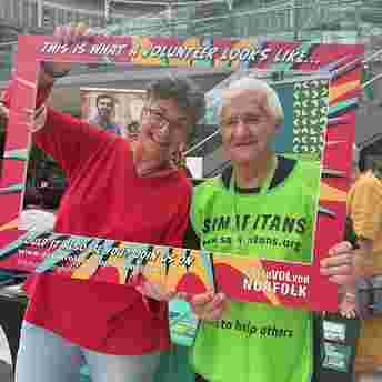 Two volunteers from the Samaritans with their faces inside a giant frame that says "This is what a volunteer looks like..."