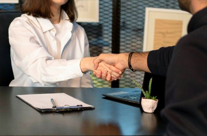 handshake during interview Photo credit Mina Rad on Unsplash 