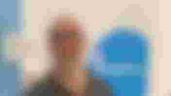 Photo of Jim wearing glasses with a grey beard, smiling at the camera, with the word Stagenhoe in the background