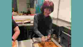 Ali Crook serves up pizza for Caudwell Youth