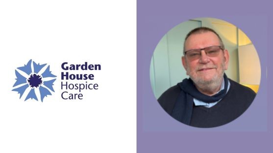 Tom, wearing glasses, smiles at the camera