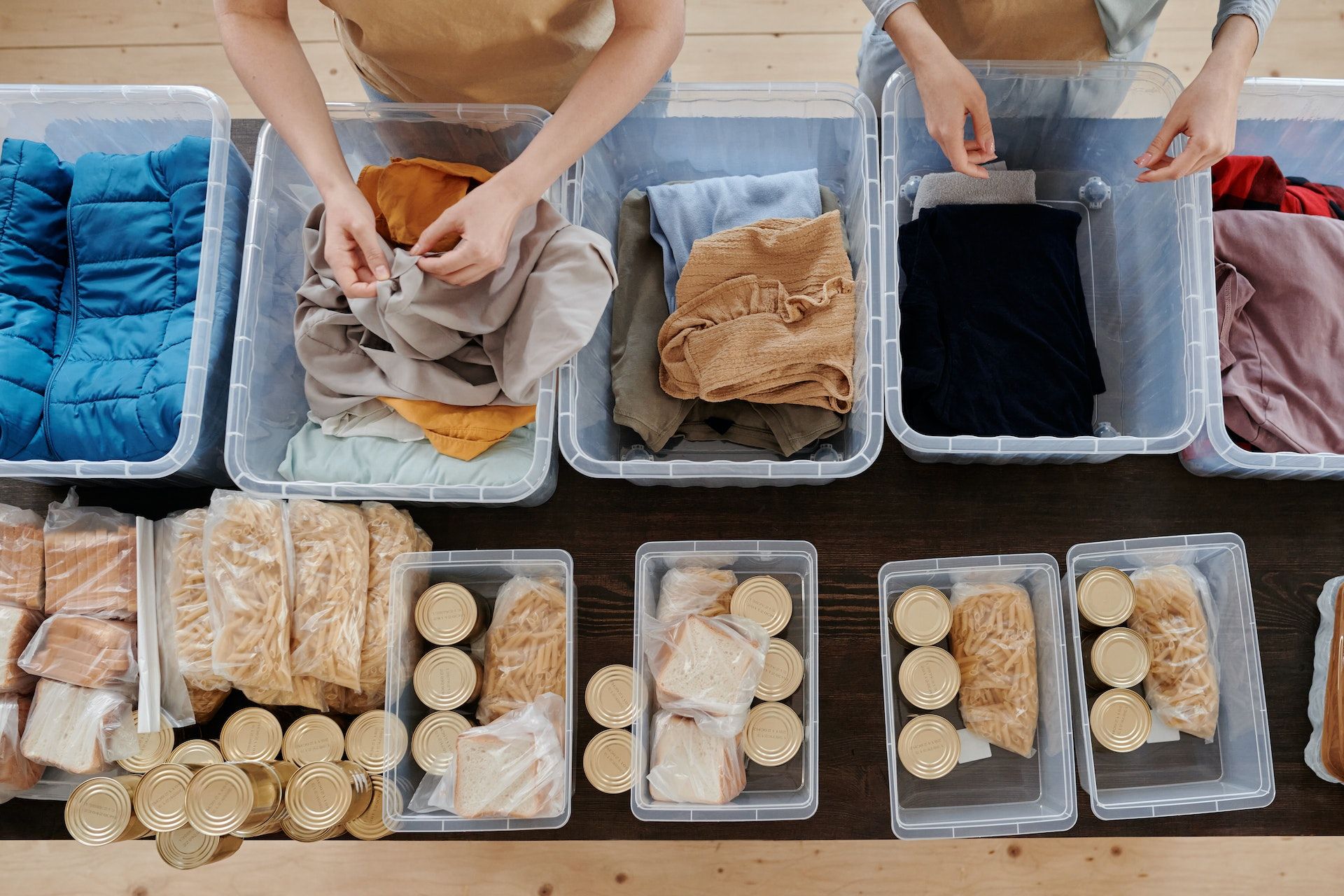 Aerial shot of people packing boxes of food and clothes.