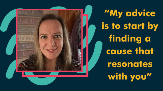 A selfie photo taken indoors showing someone wearing a cozy Fair Isle patterned sweater in browns, burgundy, and cream colors. They have long straight brown hair and are smiling warmly at the camera. In the background, there are decorative wall signs with text that includes phrases like "ALWAYS BE YOURSELF" and appears to have a unicorn theme. The lighting is warm and creates a homey atmosphere. The person appears to be in what looks like a home setting.