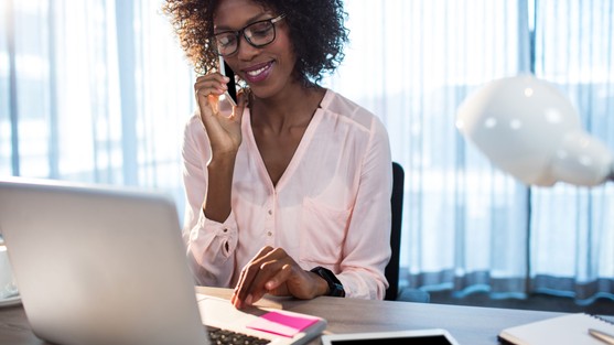 Woman on phone at computer