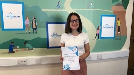 Holly holding her volunteer award from Hunts Forum.