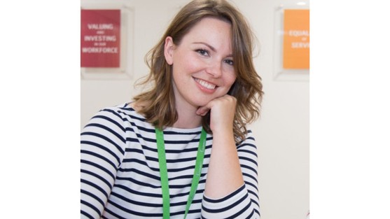 You can see a head and shoulders image of Hannah. She has shoulder length brown hair and is smiling. Hannah is wearing a stripy top and a green lanyard around her neck.