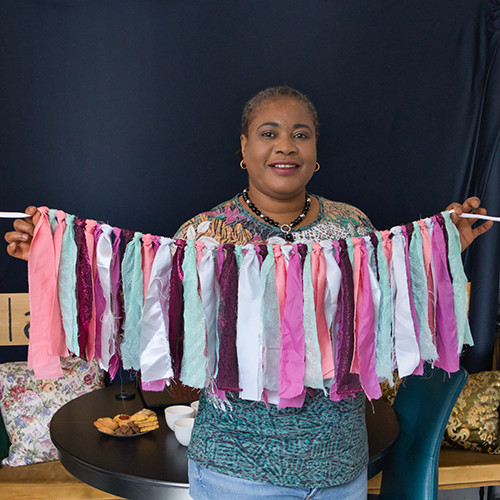 volunteer supporting sewing workshop