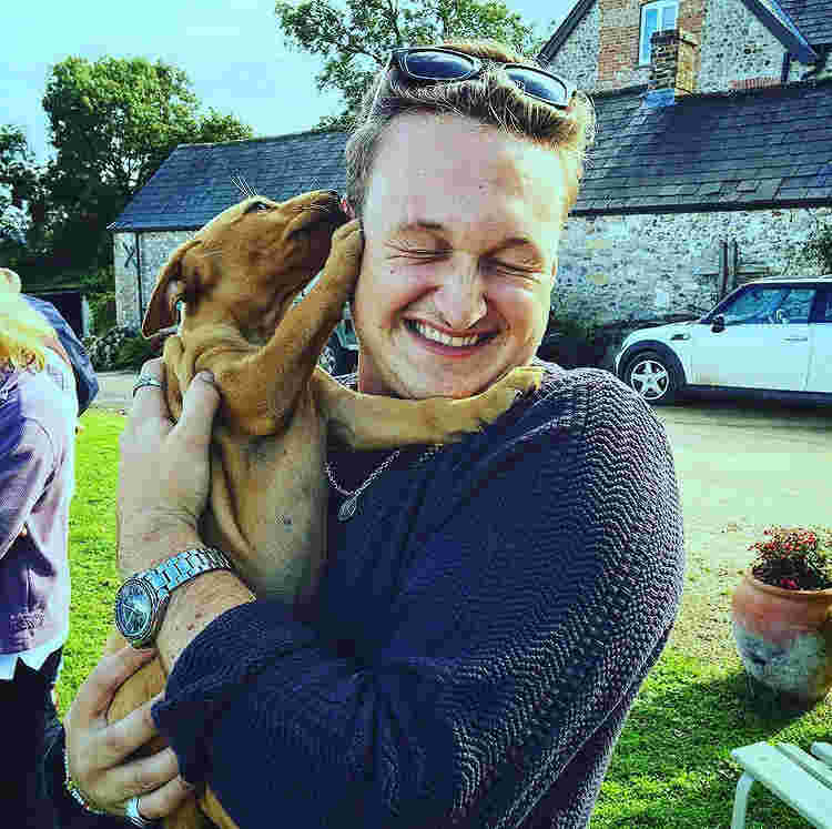 Alex holding a puppy