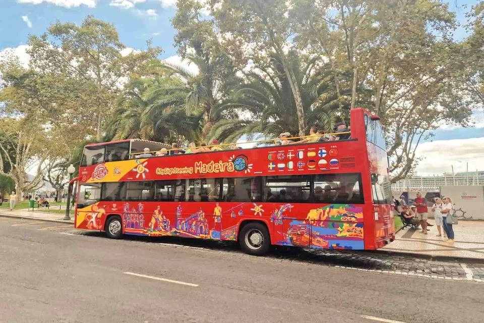 open-top City Sightseeing Hop-On Hop-Off tour bus operating in Funchal, Madeira, Portugal