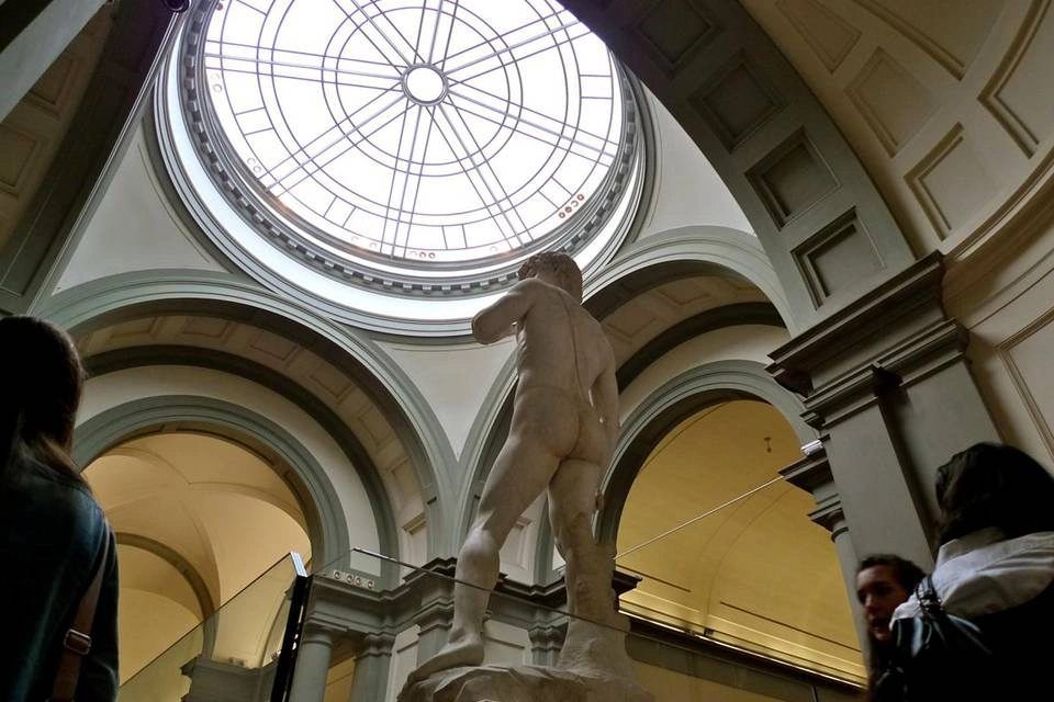 view of Michelangelo’s famous marble statue of David inside the Galleria dell'Accademia in Florence
