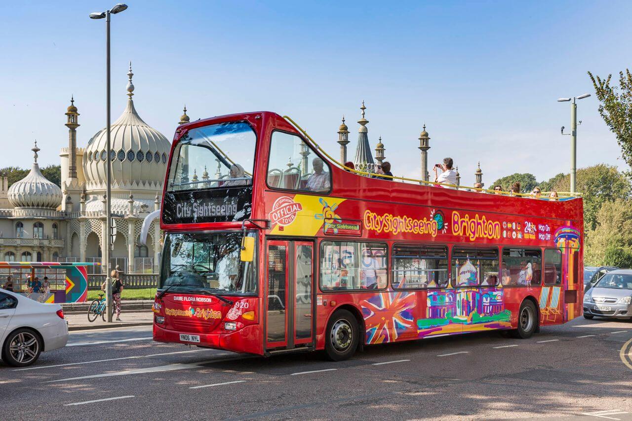 City Sightseeing Brighton Hop-On Hop-Off Bus Tour passing by the historic Royal Pavilion in Brighton