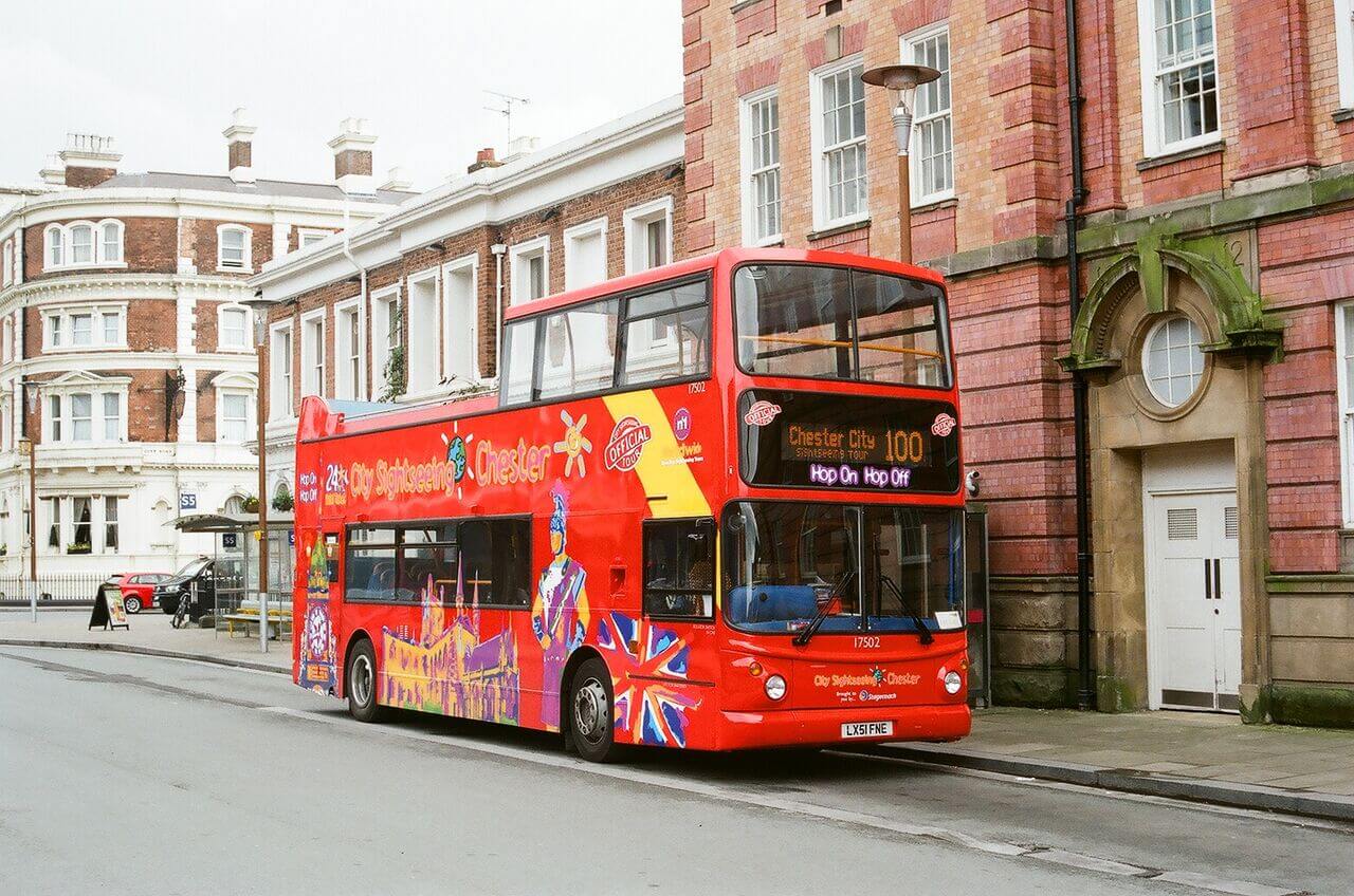 City Sightseeing hop-on, hop-off open-top double-decker tour bus parked on a street in Chester, England