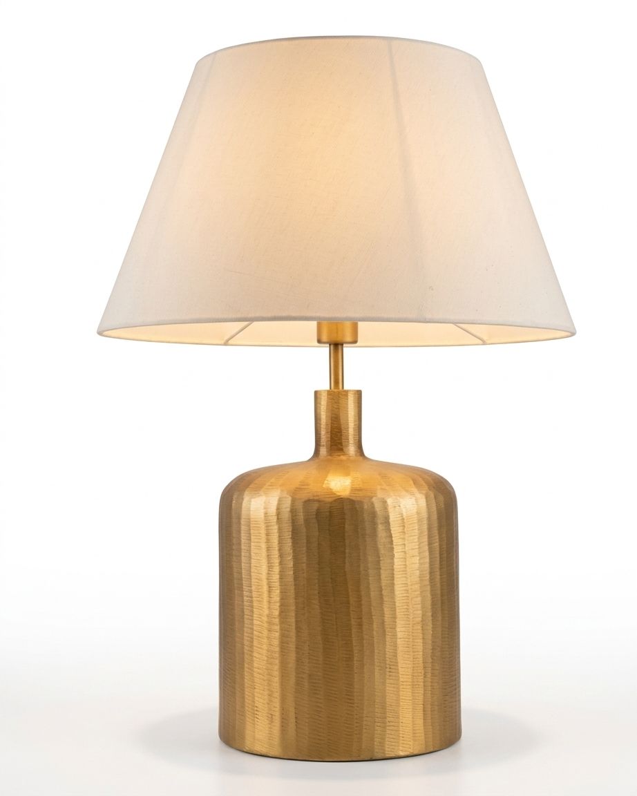 Hammered Brass Cylinder Table Lamp, a brass and fabric table lamp, studio photograph on a white background