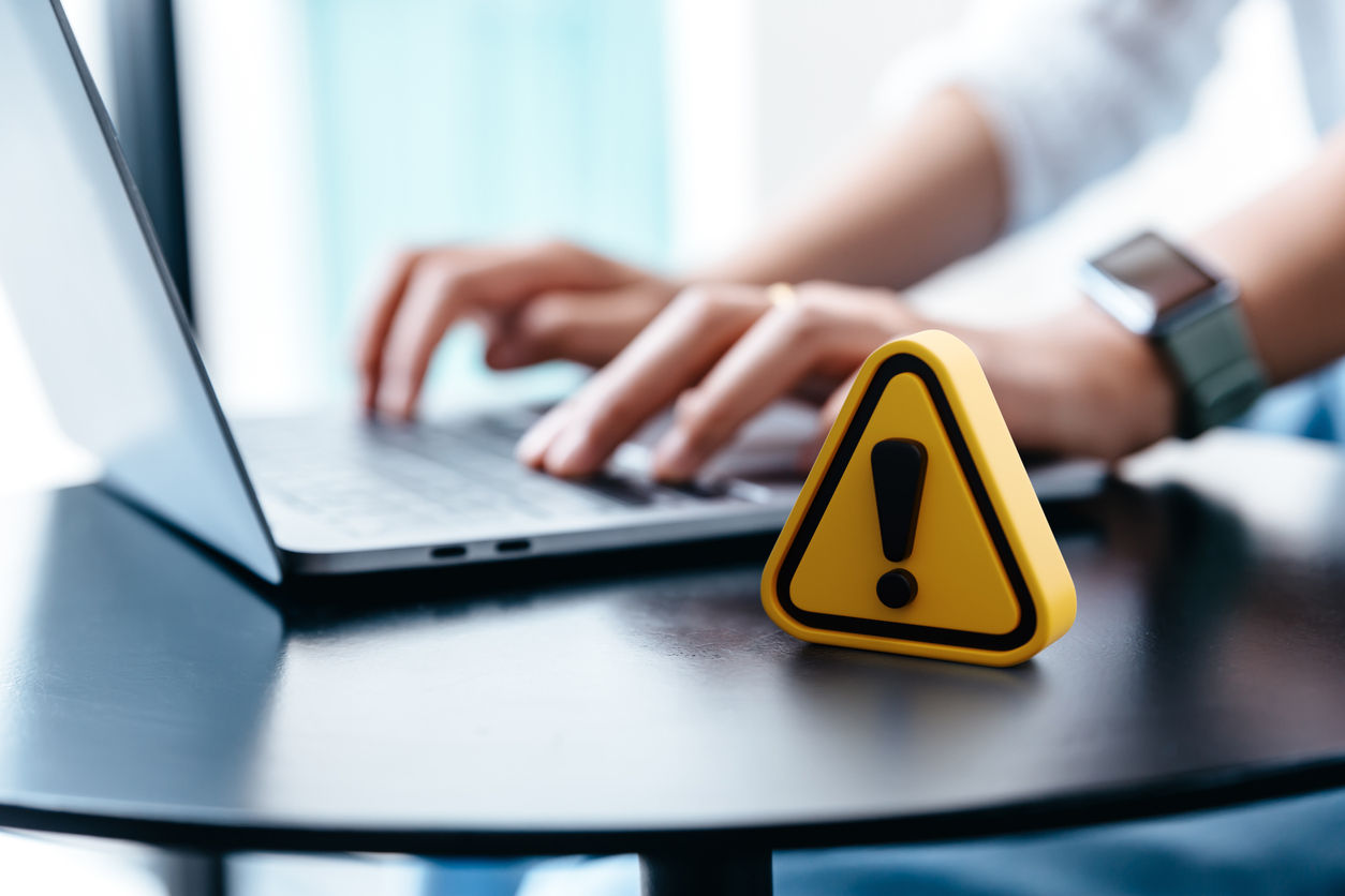 Top Financial Risks for Small Businesses and How to Protect Against Them A person working on laptop