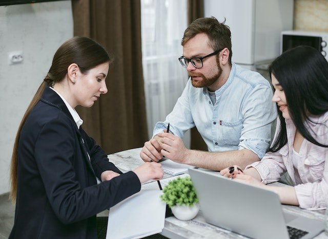 Loan-provider-discussing-a-loan-with-a-couple-at-a-desk_8TWFD5O-S.jpg
