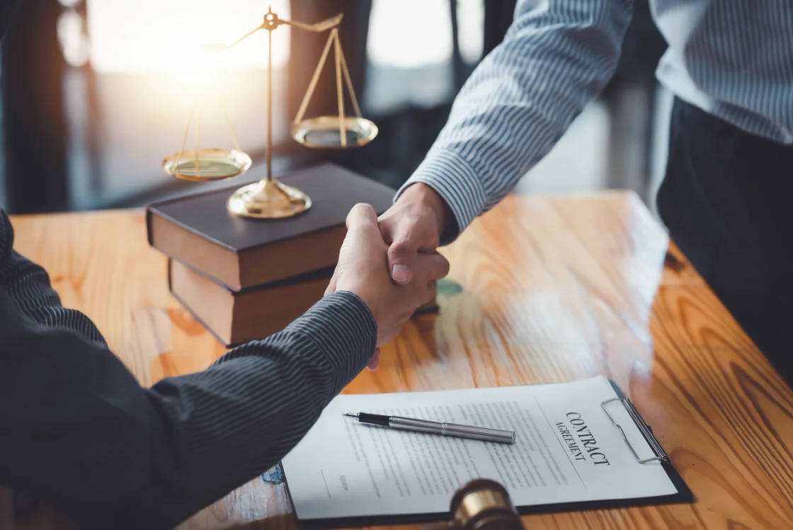 businessman-shaking-hands-partner-lawyers-or-attorneys-discussing-a-contract-agreement.webp
