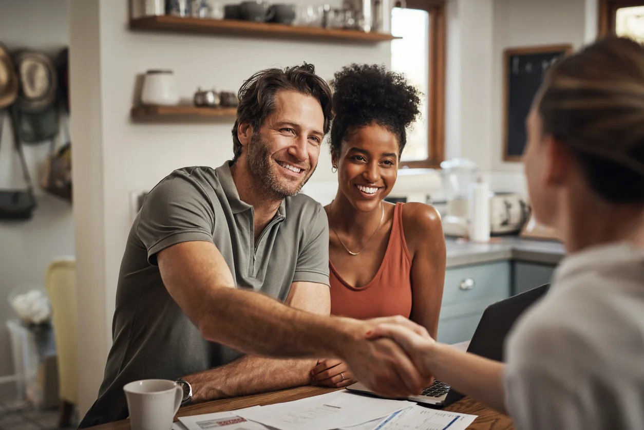 cropped-shot-of-a-handsome-middle-aged-man-shaking-hands-with-a-financial-advisor-during-a-consultation-at-home.webp