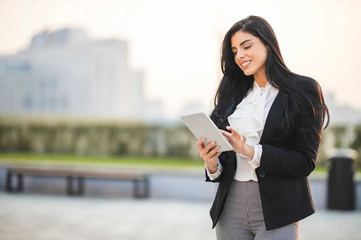 portrait-of-businesswoman-using-digital-tablet-and-working-outdoors.webp