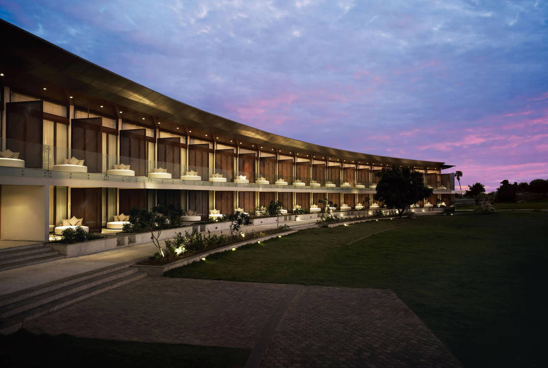 Taj Fisherman's Cove Resort & Spa exterior at twilight — guest wings and conference setting