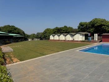 Aranyam’s Tent Camping Mahabaleshwar Retreat — lawn, pool, and cottages