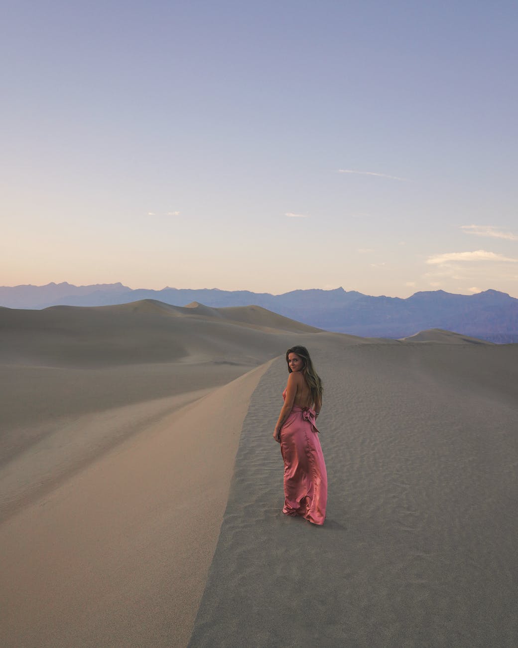 photo of woman walking on dessert