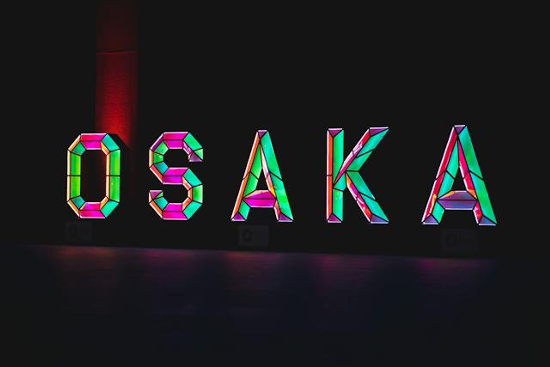 neon light osaka words with green gem theme