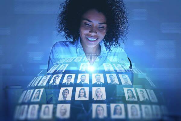 African American Women Looking At A Virtual Sphere With Diverse Faces