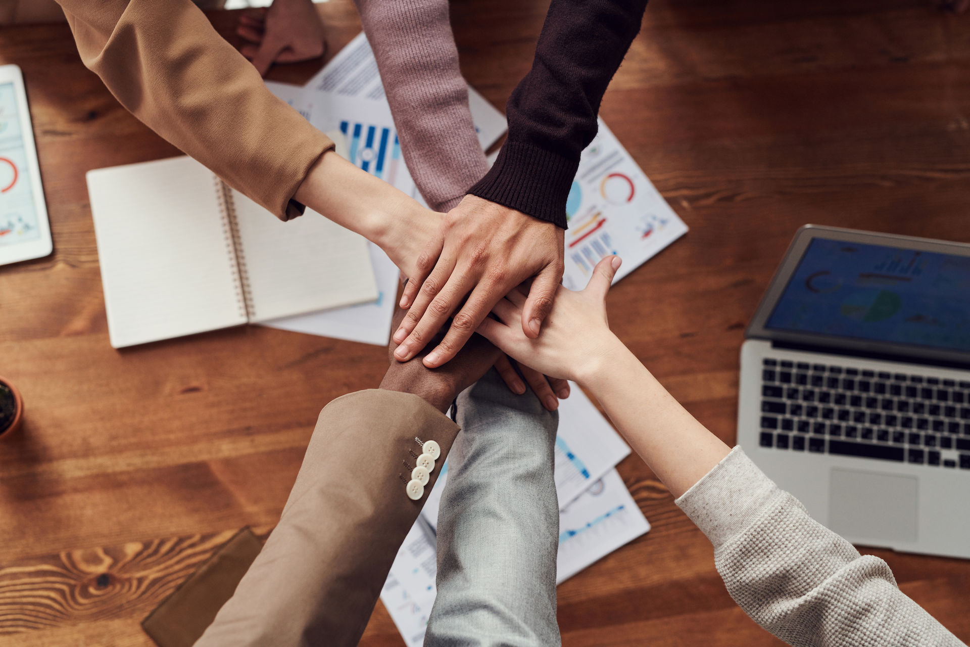Employee huddle with hands in the middle