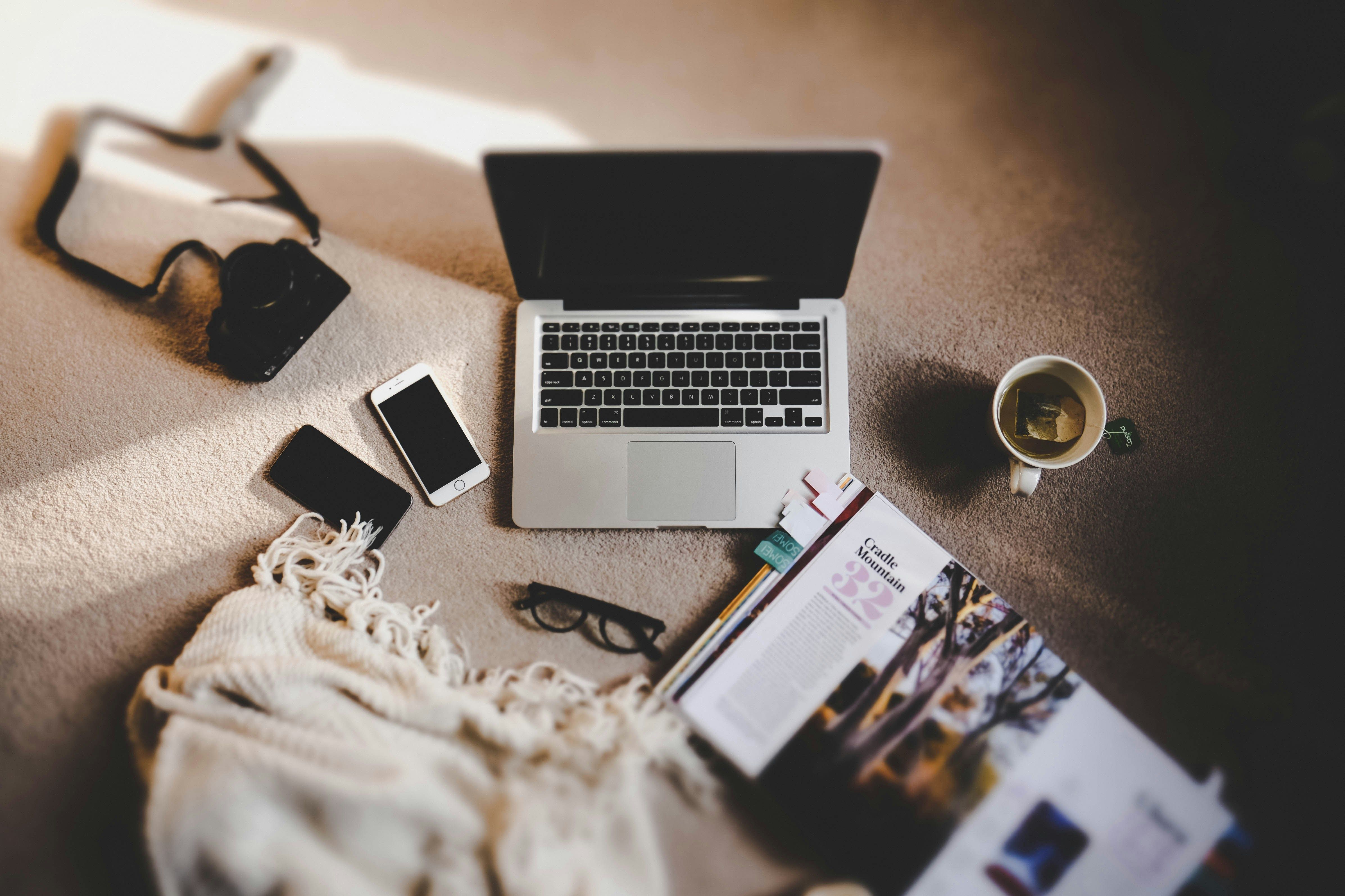 A laptop open on a desk with a notebook beside it, representing someone learning a new freelance skill from scratch
