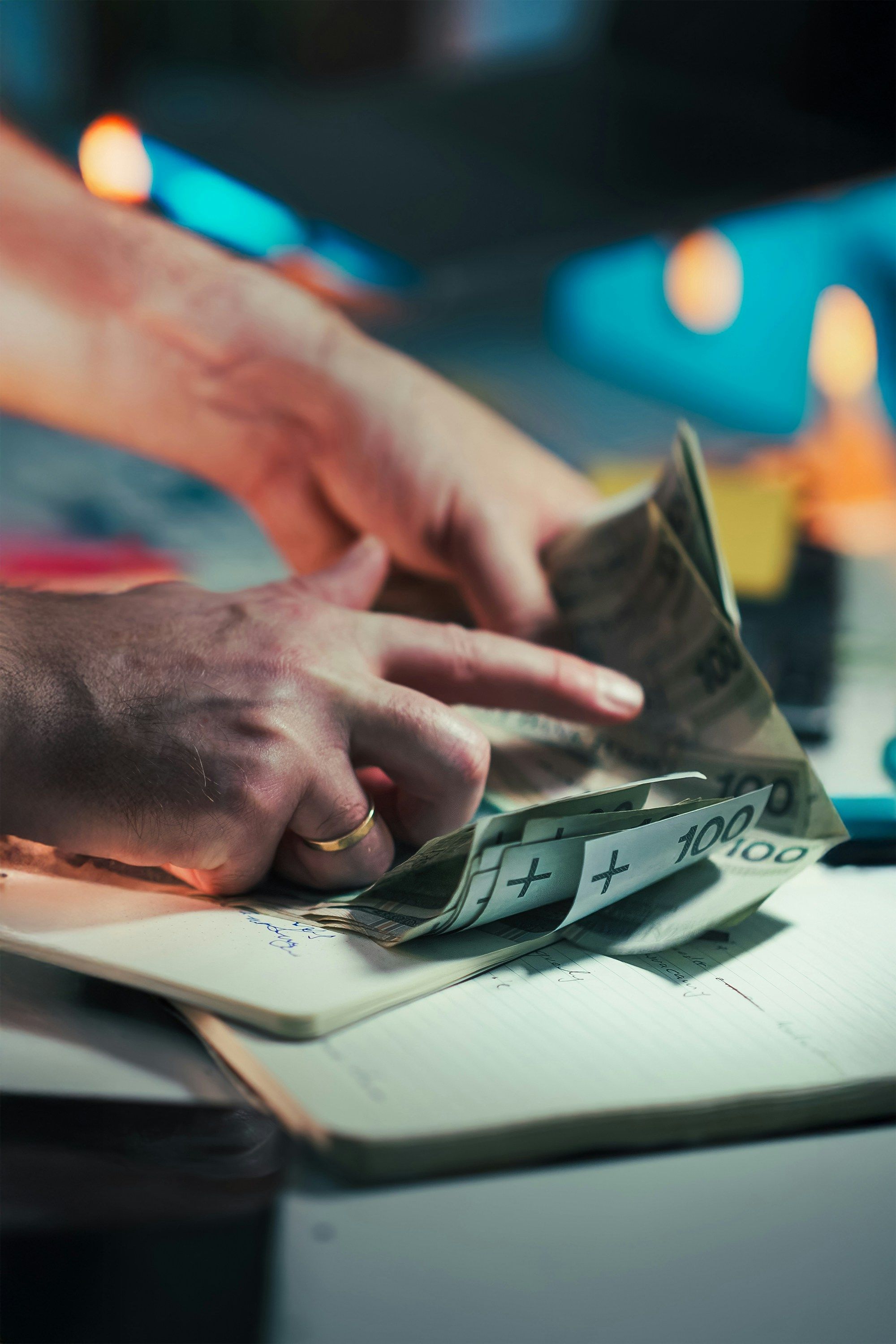 A person smiling while looking at their savings balance growing on a phone