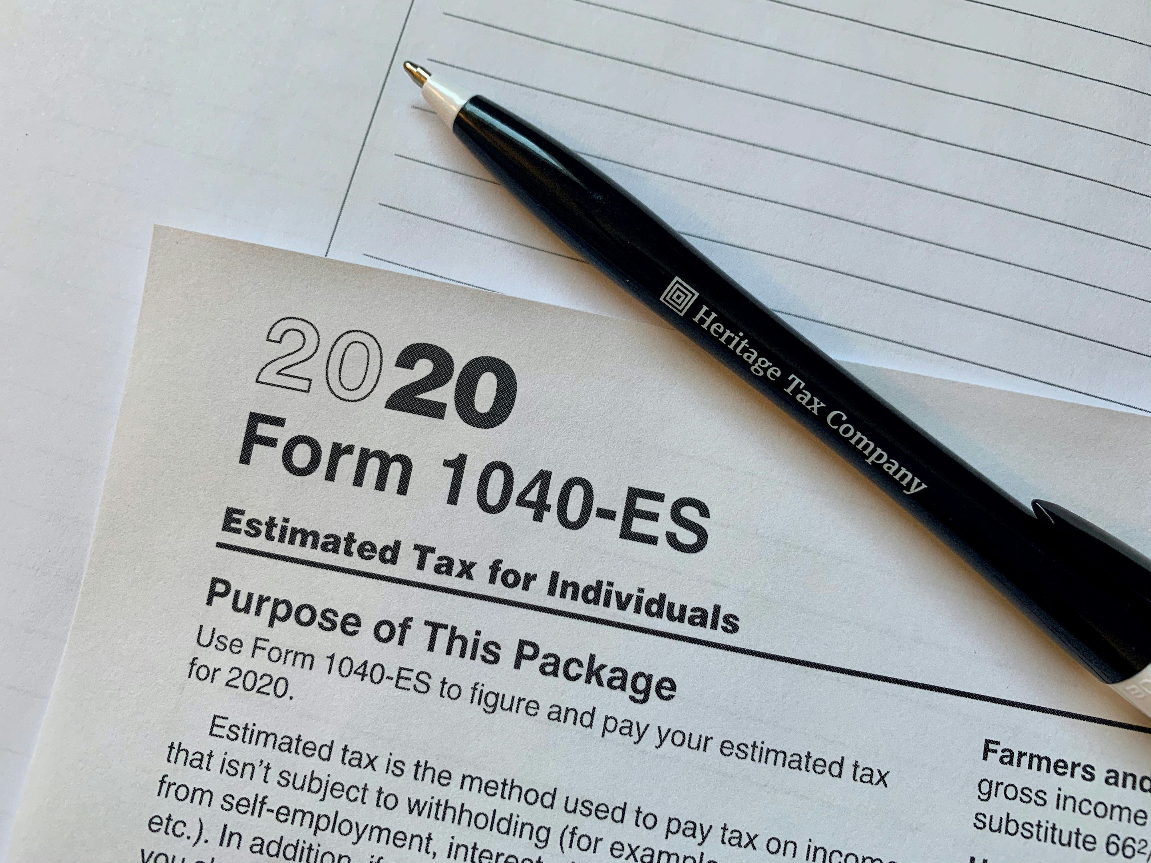 A man reviewing tax documents and retirement account statements at a kitchen table