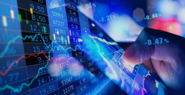 A digital stock ticker board showing major tech company names and prices