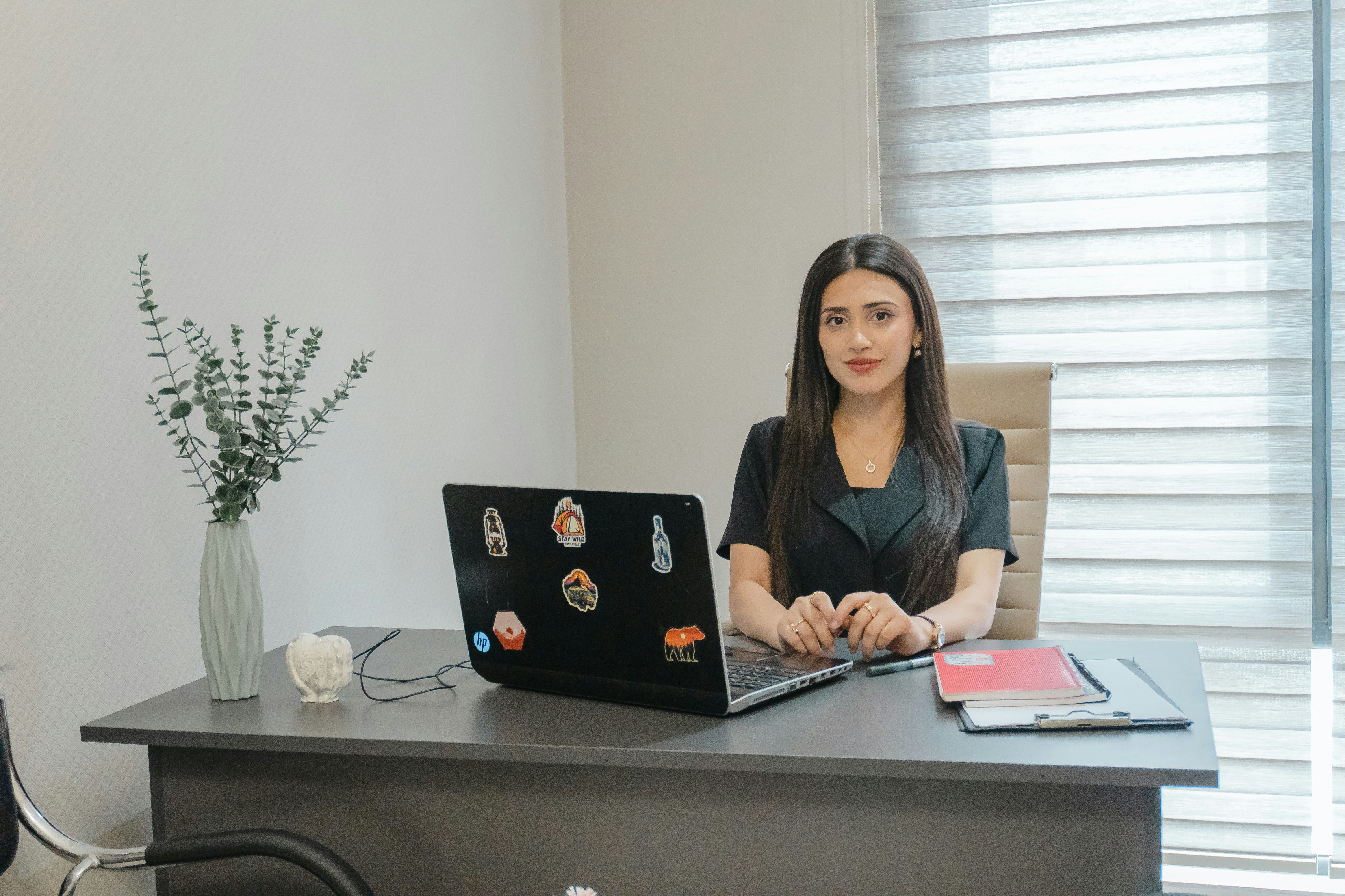 A person doing a telehealth video call with a doctor on a laptop
