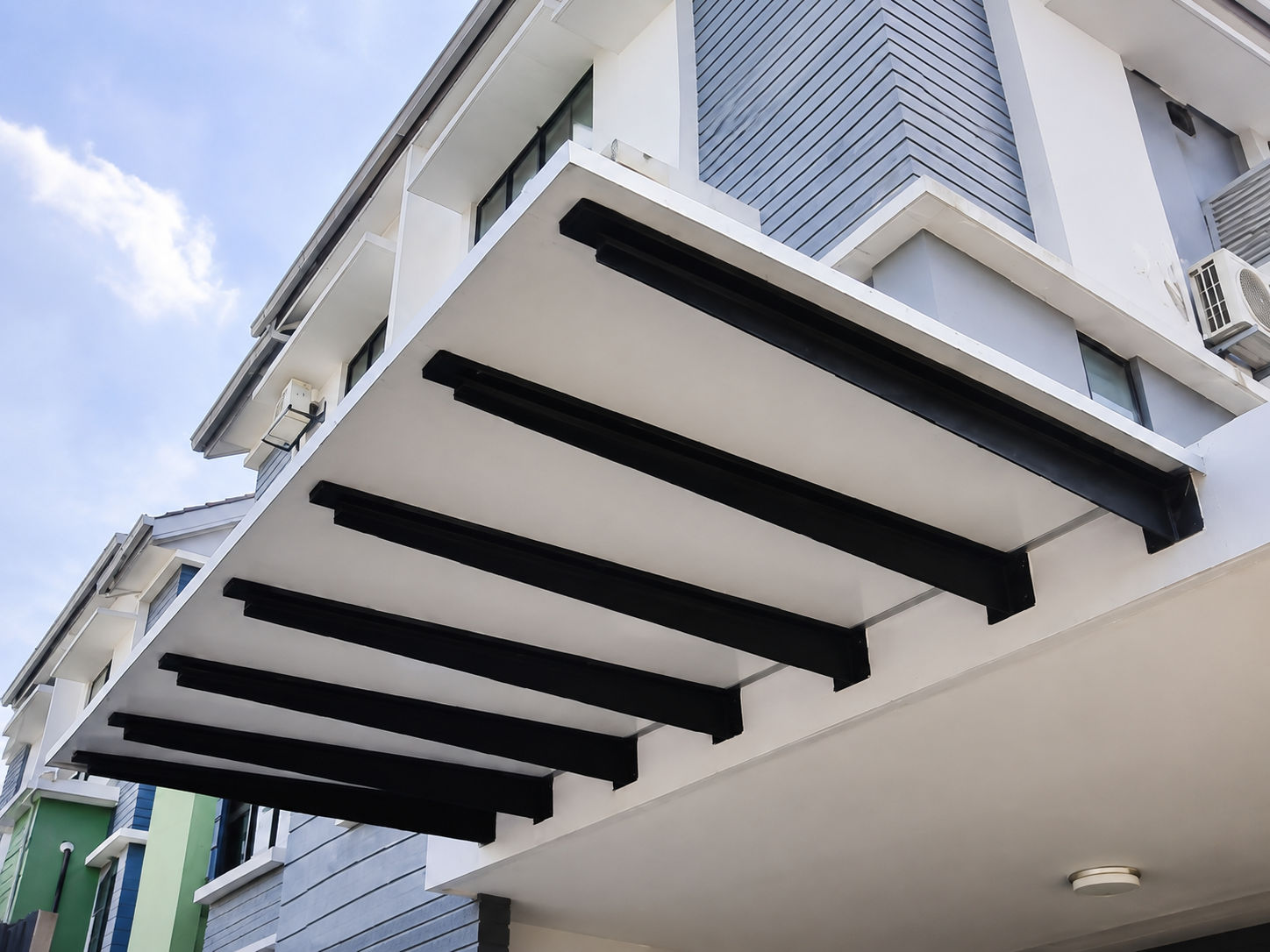 ACP pergola structure with white panels over a driveway