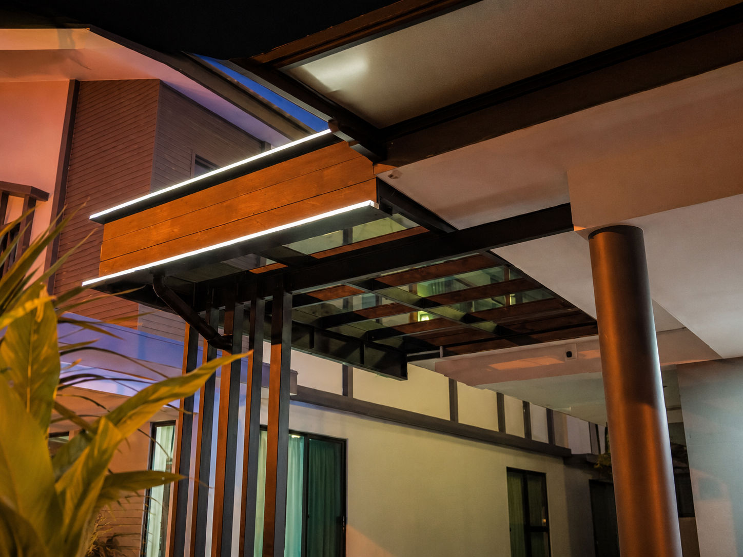T-Light LED Awning with woodgrain fascia and integrated LED strip lighting at night