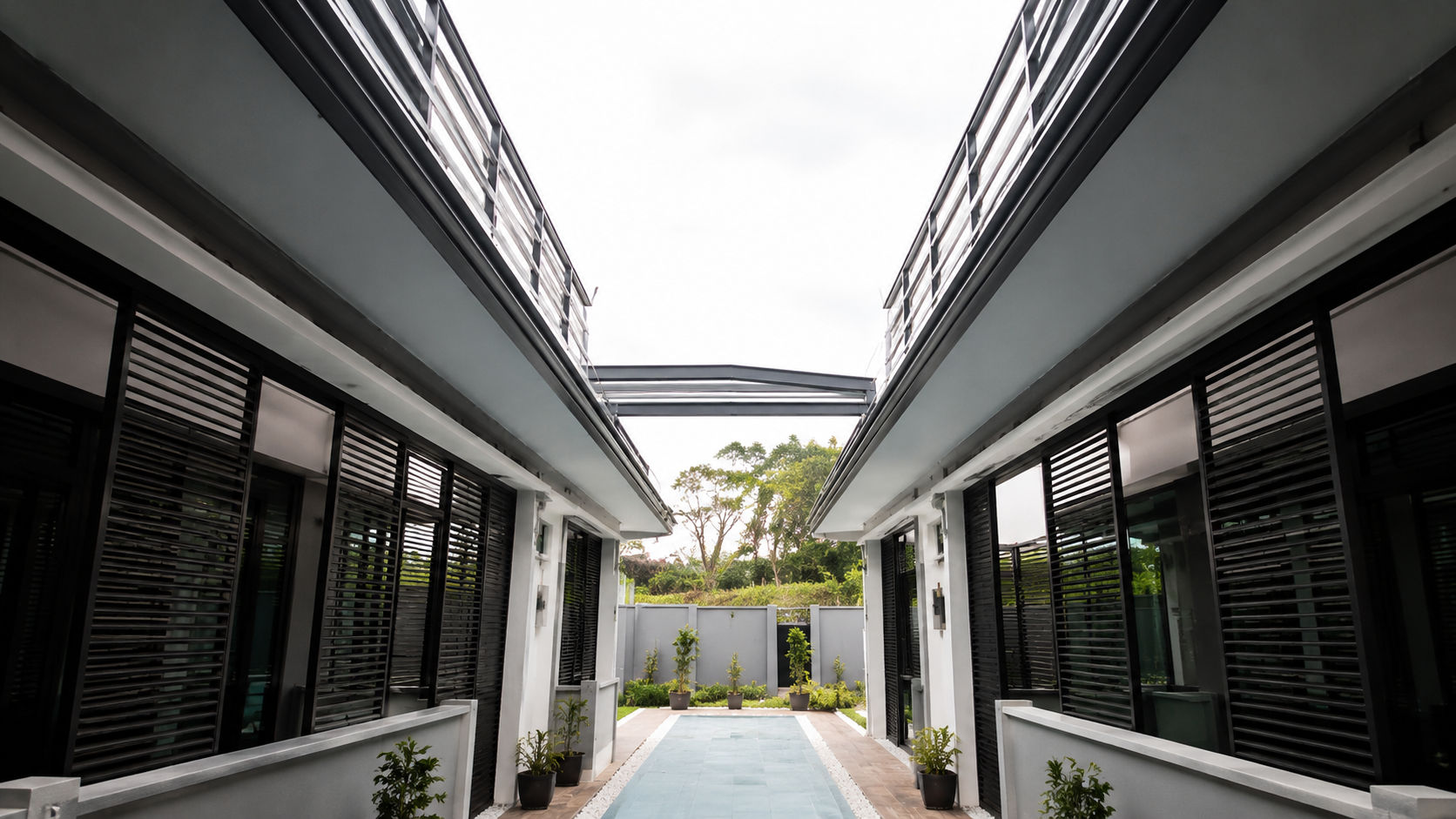 Tettro retractable roof fully open over a residential courtyard walkway