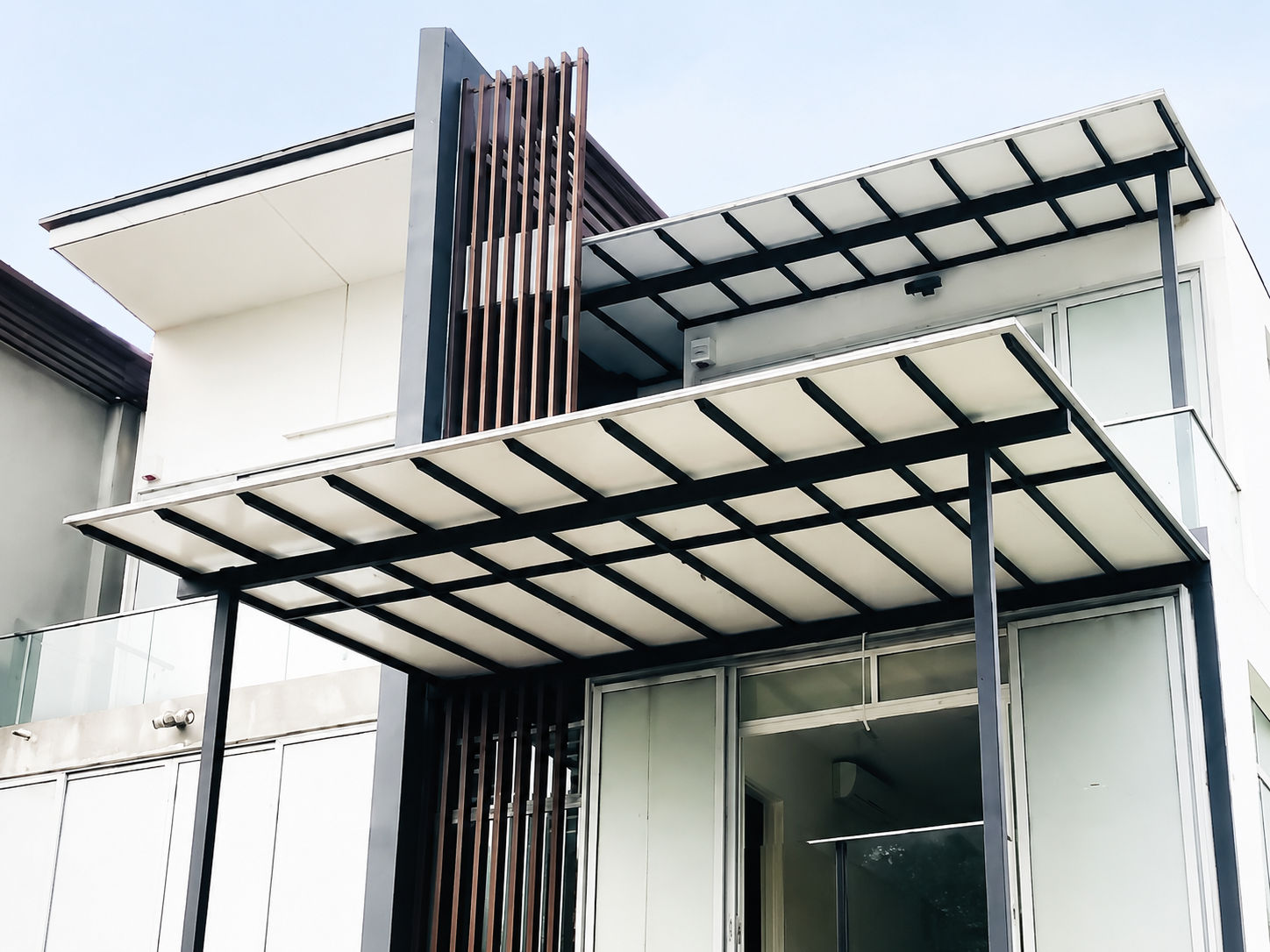 Aluminium composite panel awning on a modern white residential building
