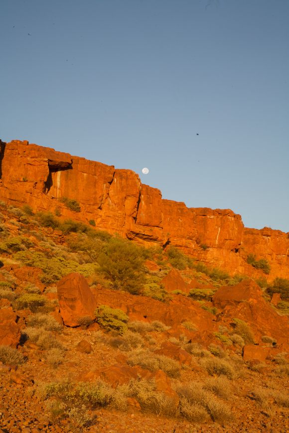 The moon rising over a ridge.