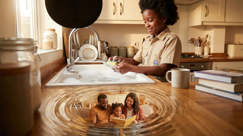 An illustration showing a Scout's positive action (helping with dishes) radiating outward like ripples in water, with family members smiling in response