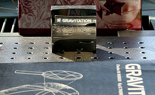 Look at the image carefully… the mirror is reflecting the text from the spine of the book, without inverting the text! Genius!