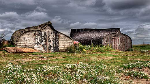 Great picture from Lindisfarne (Holy Island) in England where fishermen recycle their old boats by turning them upside down and creating a storage shed