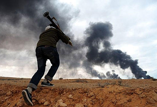 A photo of a Libyan rebel fighter carrying a rocket propelled grenade