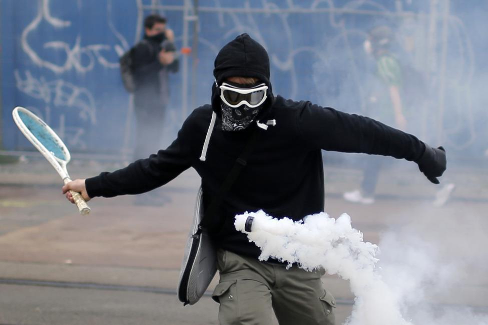 Reuters Pictures of the year 2016 : A protestor uses a tennis racket to return a tear gas canister during a demonstration to protest the government's proposed labour law reforms in Nantes
