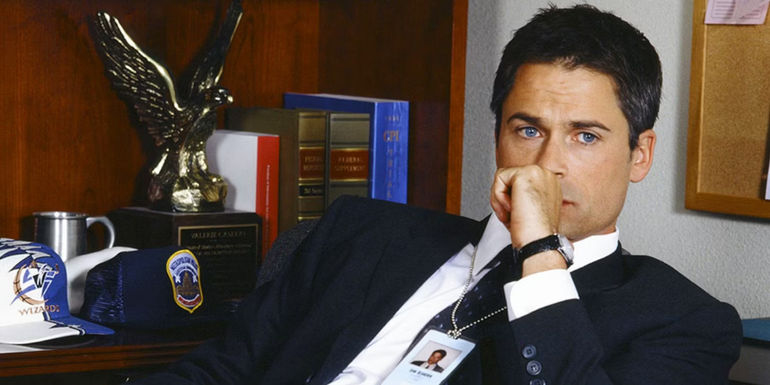 Sam Seaborne (Rob Lowe) leaning back on his chair in West Wing