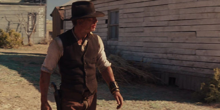Daniel Craig walking into a Western-style down as Jake Lonergan in Cowboys & Aliens