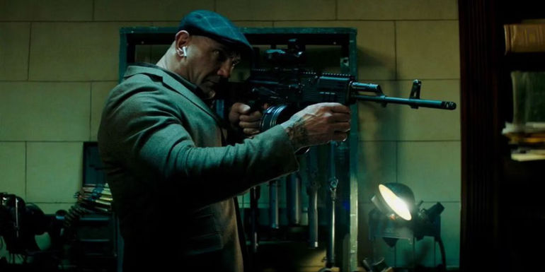 Dave Bautista as DeRosa pointing a rifle in Escape Plan 2