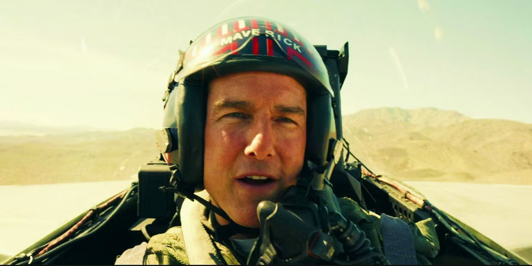 Tom Cruise as Maverick speaking while in a fighter jet cockpit in Top Gun: Maverick.