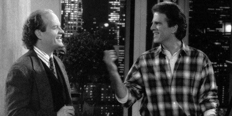 Frasier Crane and Sam Malone talking and smiling in Cheers