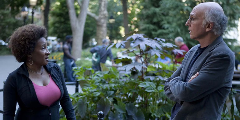 Wanda Sykes looks at Larry David who stands with arms crossed in Curb Your Enthusiasm