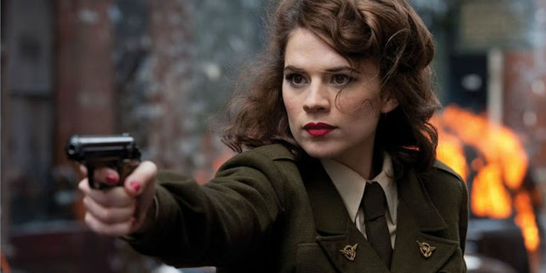 Hayley Atwell as Captain Carter holding a pistol